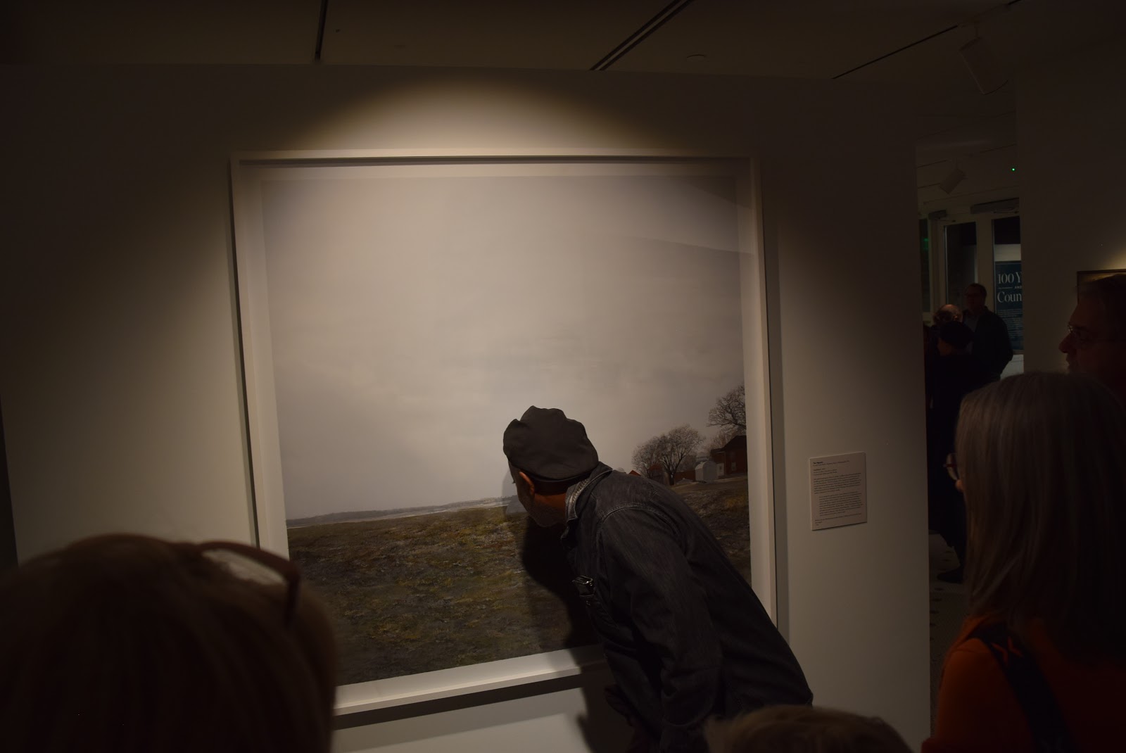 A Minnesota Museum of American Art visitor gets up close to inspect the details in Teo Nguyen's  painting "Untitled I.”