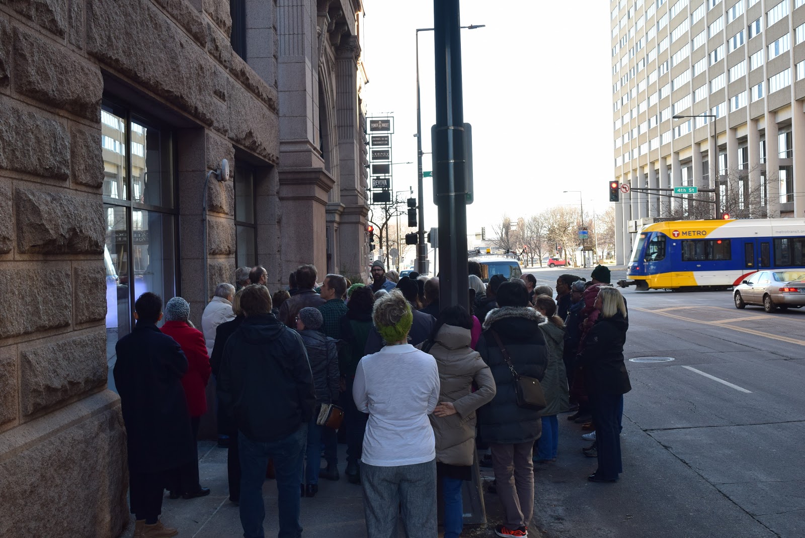 Visitors cluster around The M's Window Gallery to view David Bowen’s "Waveline." The museum’s new space in the Pioneer Endicott building in downtown St. Paul is located one block from Central Station of the Green Line light rail.