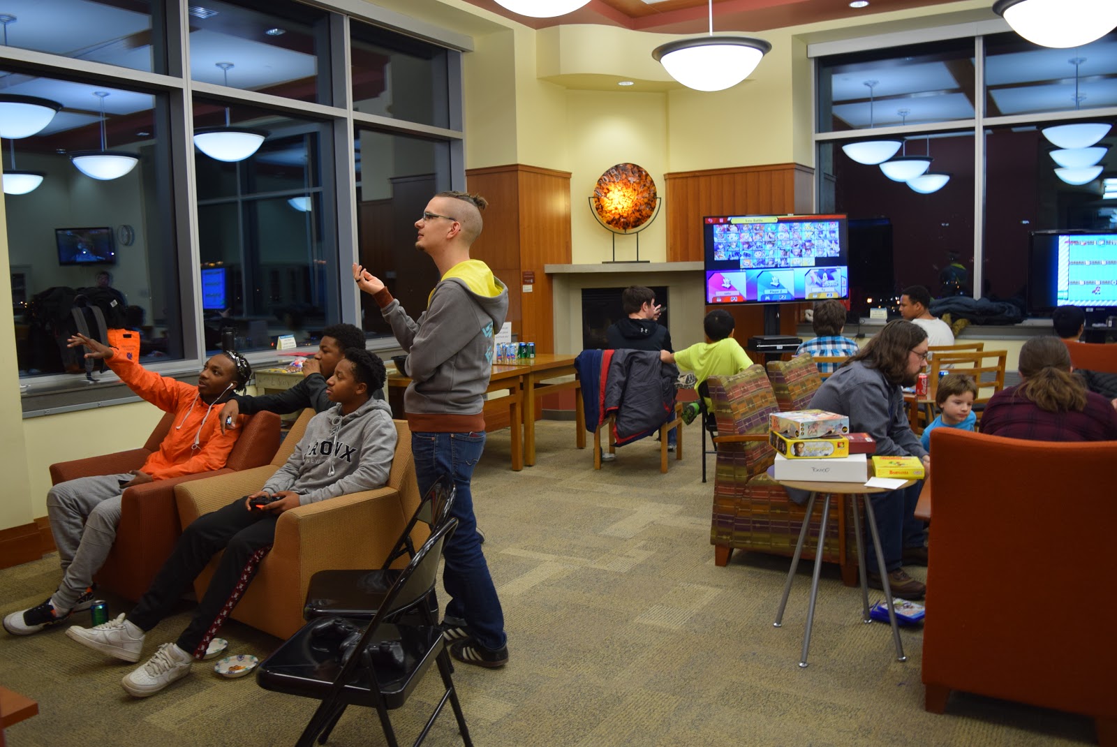 Librarian Zorian Sasyk, standing, with video gamers at Game Night on Feb. 19, 2019. (Margot M. Barry / The Metropolitan)