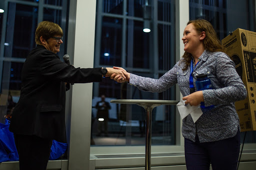 President Ginny Arthur, left, congratulates an award-winning student researcher at the Student Poster Conference in New Main Great Hall on Wednesday, Nov. 28, 2018. Photo by Eli Bartz
