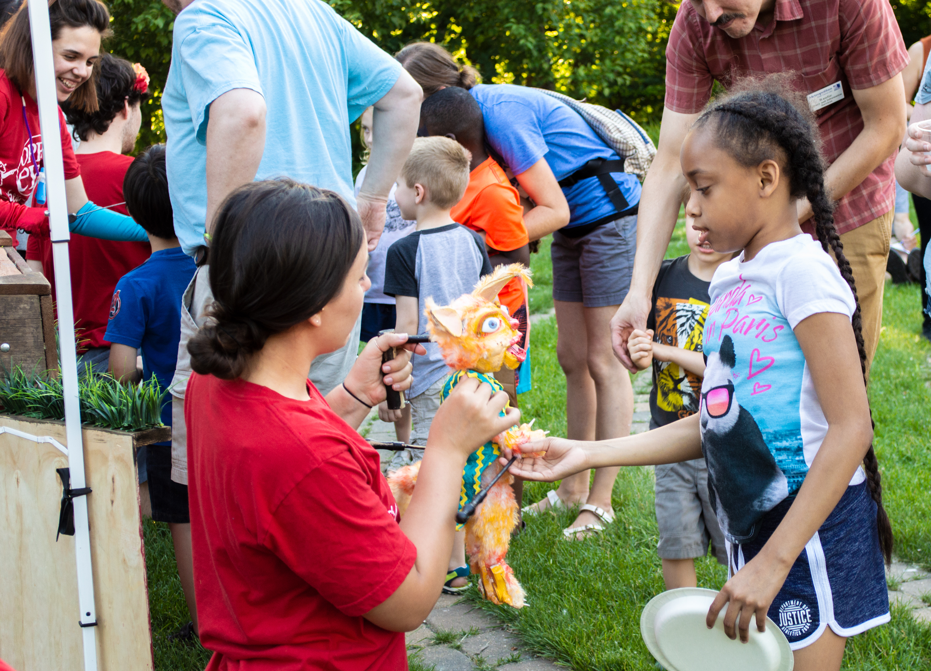 Emily Rose Duea and other puppeteers introduce the stars of the show to a fascinated audience after their June 26 performance. (Mandy Hathaway / The Metropolitan)