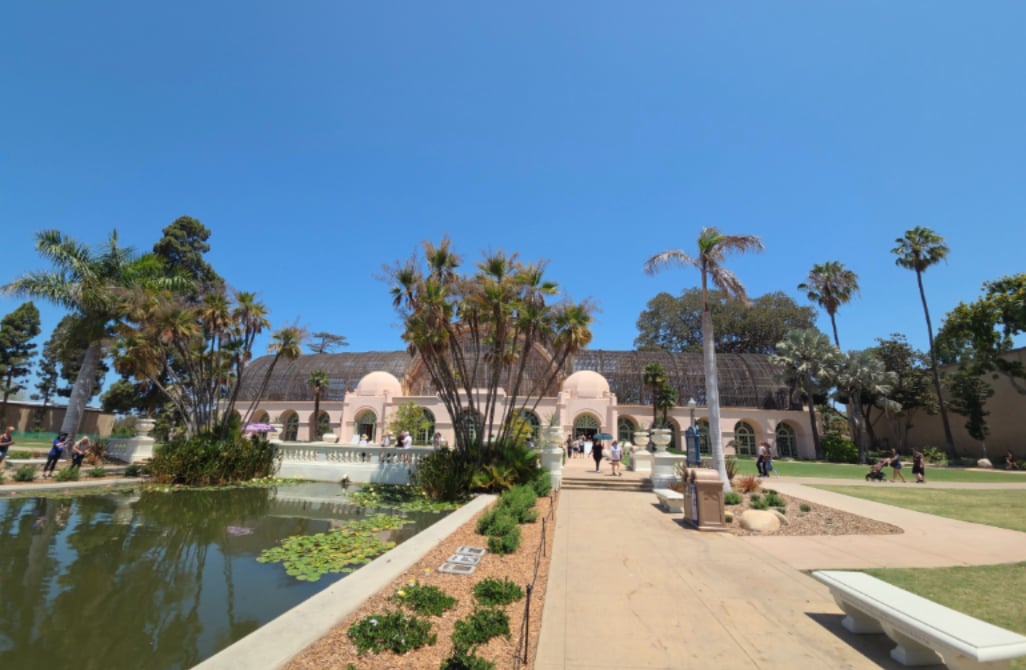 Palm trees and lily ponds surround the historic Botanical Building at Balboa Park in San Diego.